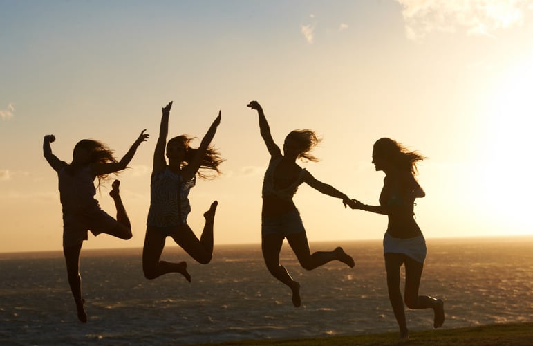 Feeling on top of the world. Silhouette of a group of girlfr